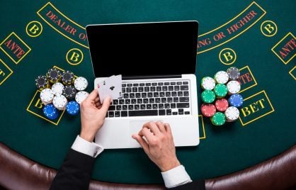 man playing blackjack on laptop