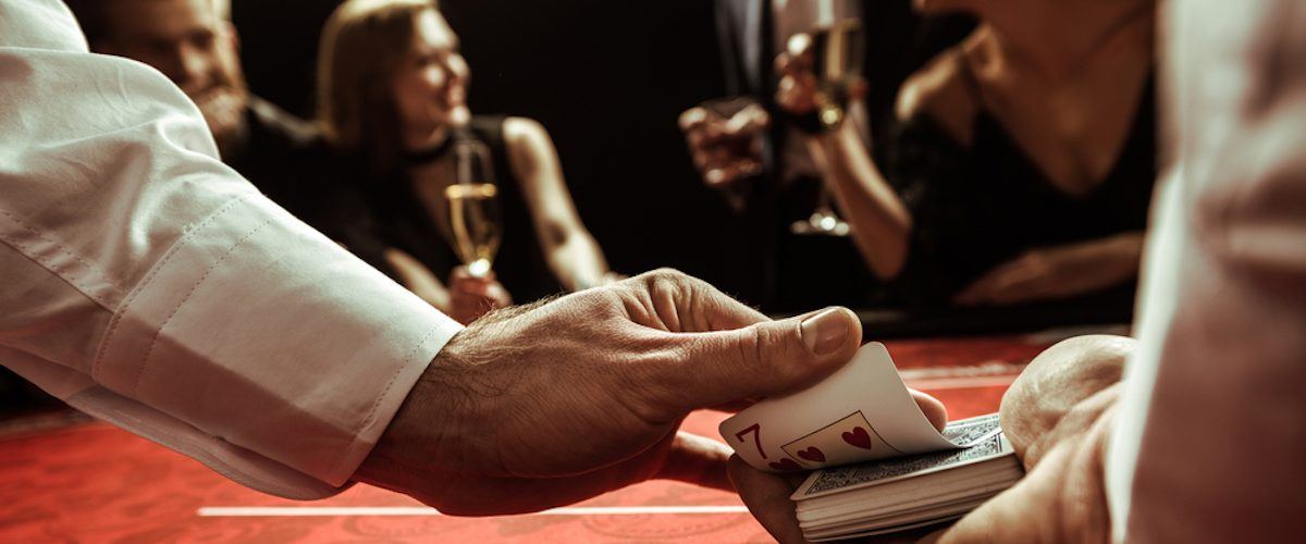 close up view of dealer shuffling cards in hands