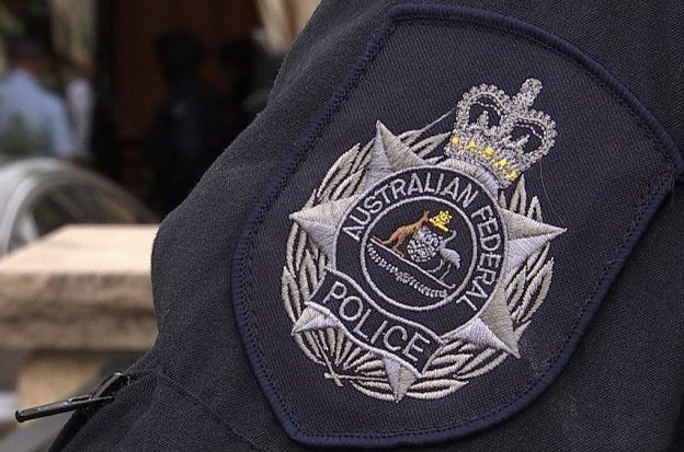 The badge of the Australian Federal Police on an officer's uniform