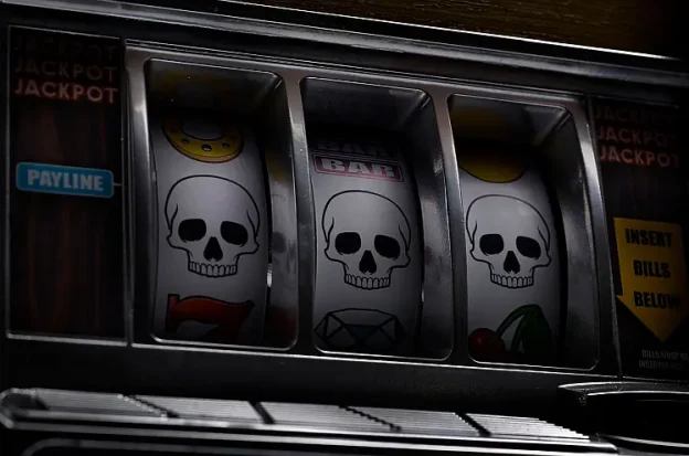 A slot machine showing a payline of three skulls