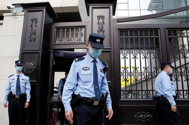 Chinese police stand guard outside a courthouse