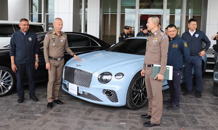 Thai police stand by a luxury vehicle